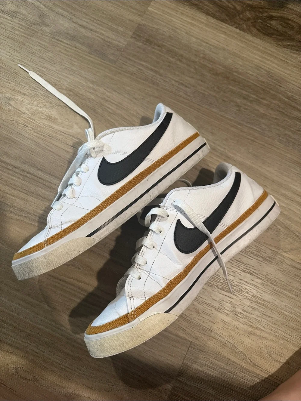 Nike White Low-Top Sneakers with Black Swoosh and Tan Trim court legacy